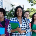 International students holding books while studying in Canada