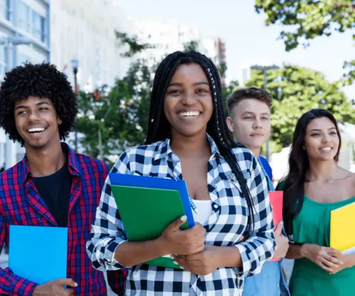 International students holding books while studying in Canada